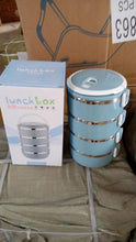 Stainless steel lunch box with four layers for hot food.